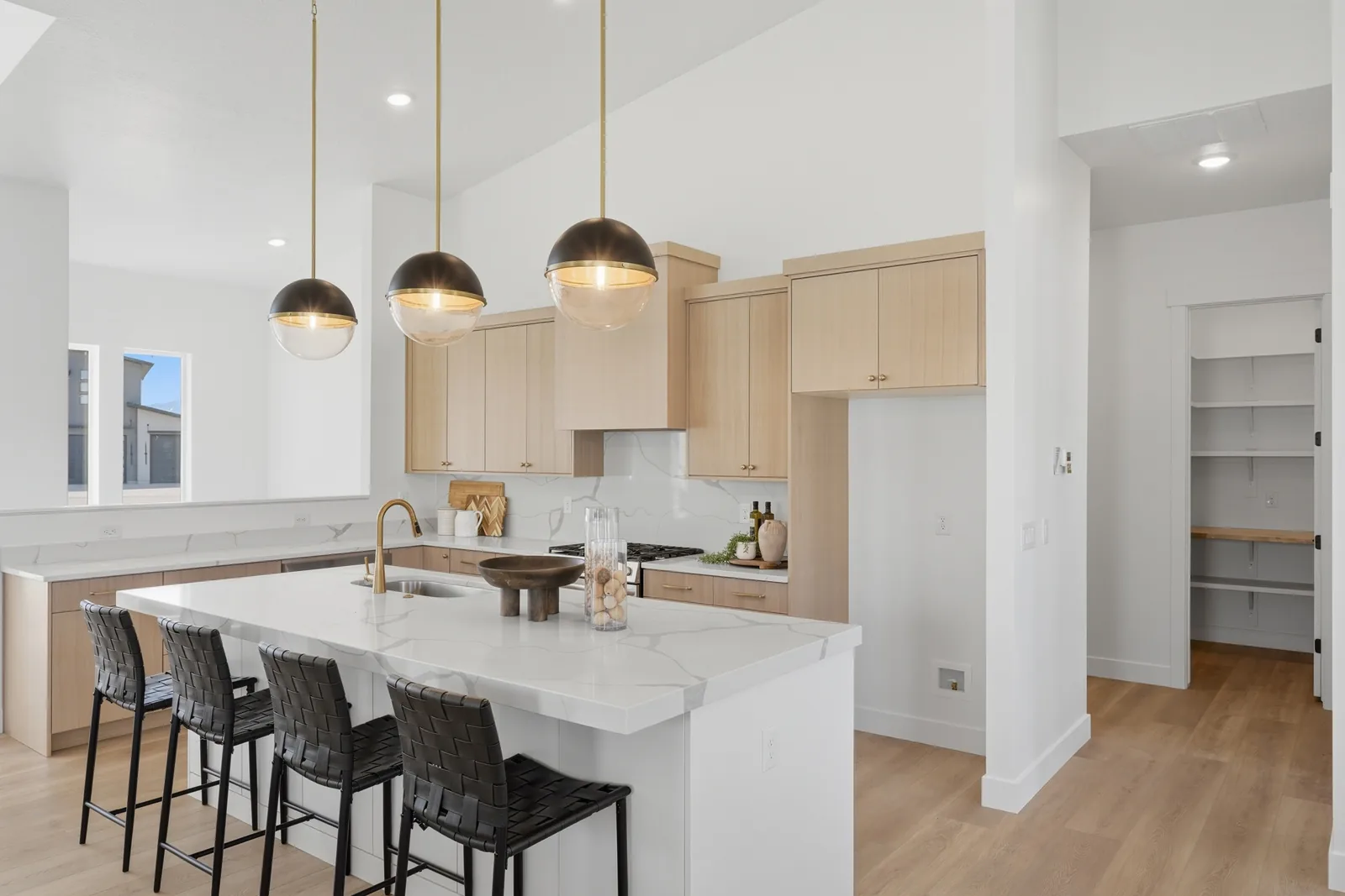Chestnut Modern kitchen with warm cabinetry and island seating
