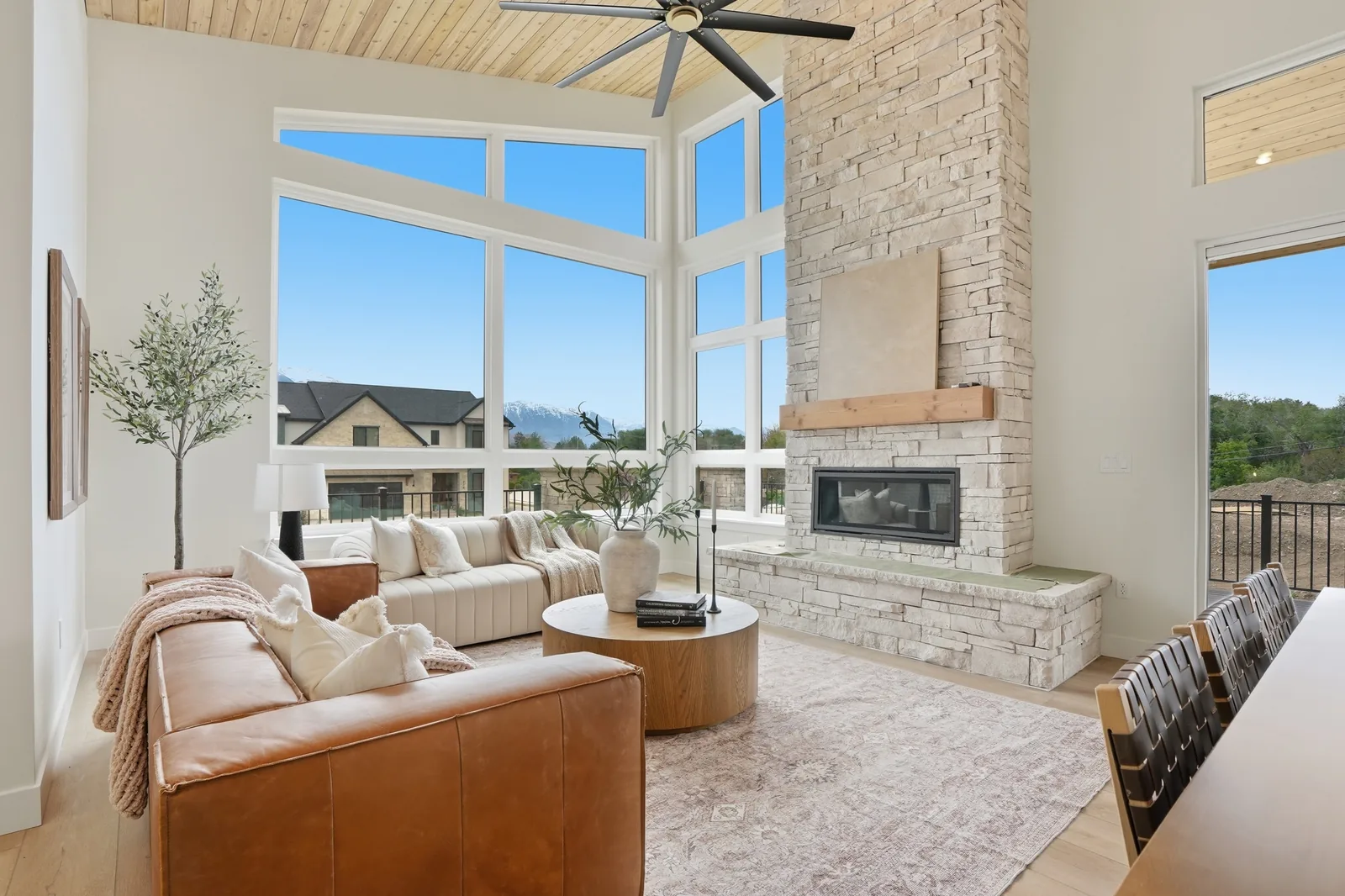 Denali II living room with broad windows, fireplace, and mountain views
