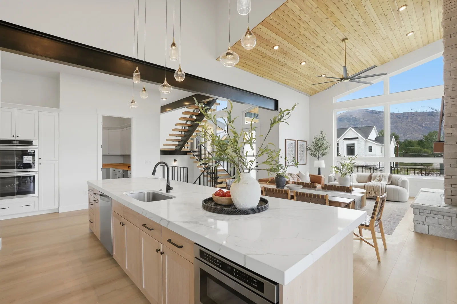 Denali II open kitchen and living room with warm timber ceiling details