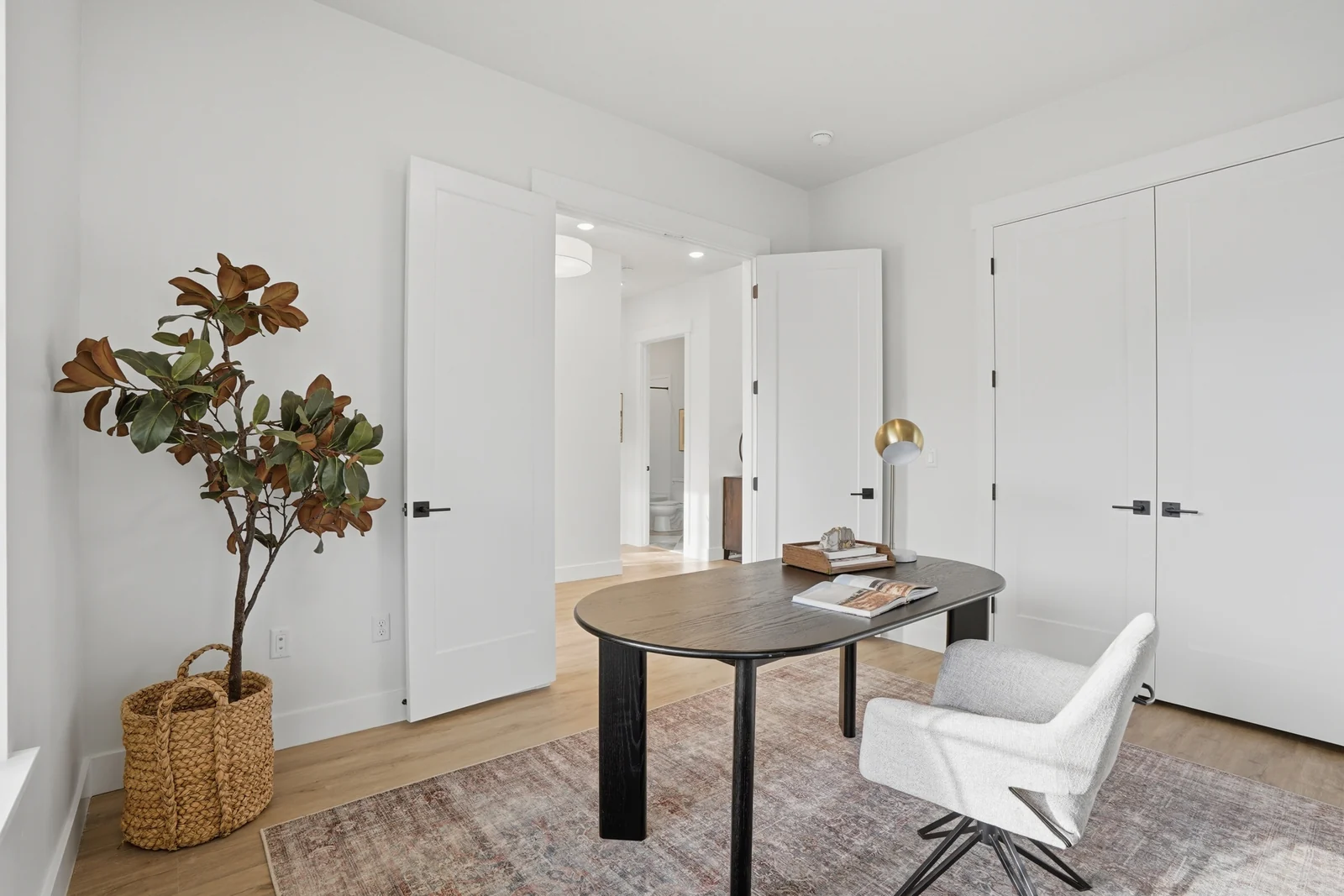 Alternate view of the home office with worktable, chair, display cabinet, and natural light in Olympic BH08, American Fork.