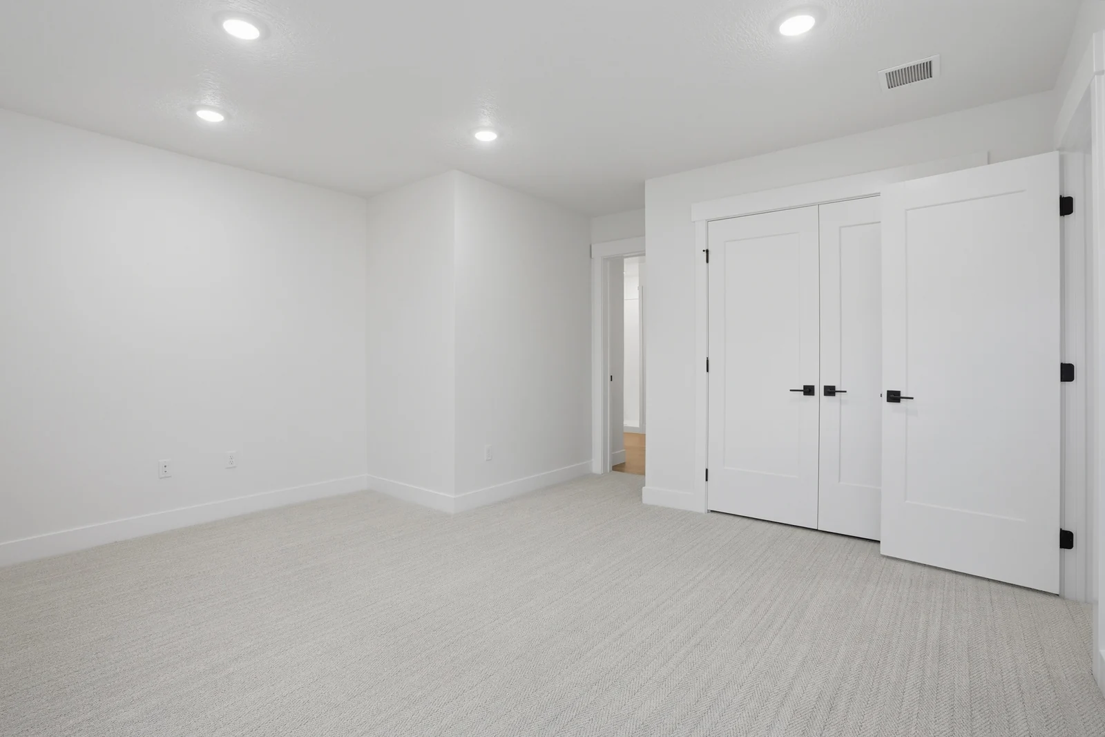 Bright unfurnished flex room with double closet doors, recessed lights, and neutral carpet in Olympic BH08, American Fork.