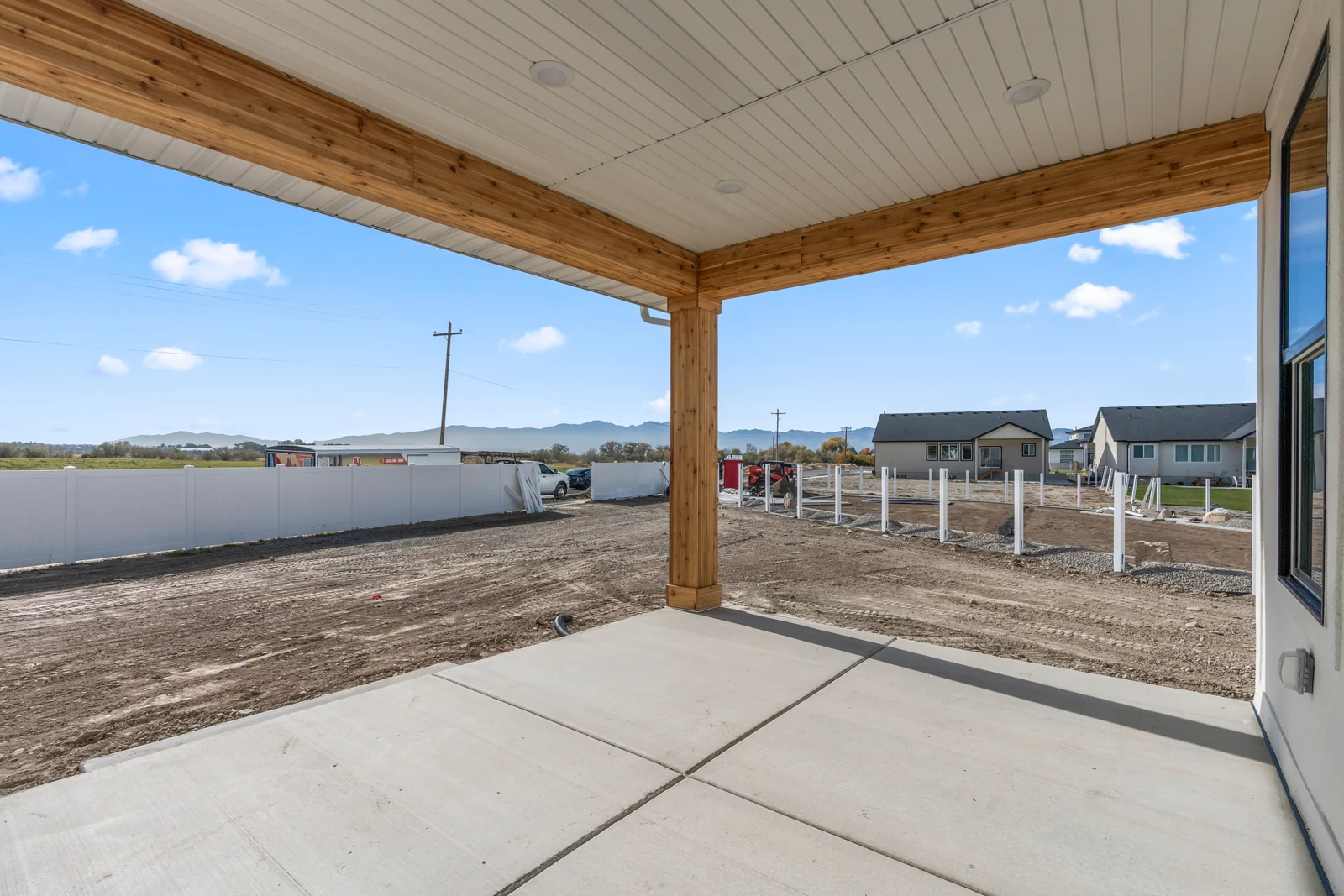 Unfinished lower-level room with concrete foundation walls, exposed ceiling framing, and poured concrete floor at Chestnut MW311, Stansbury Park.