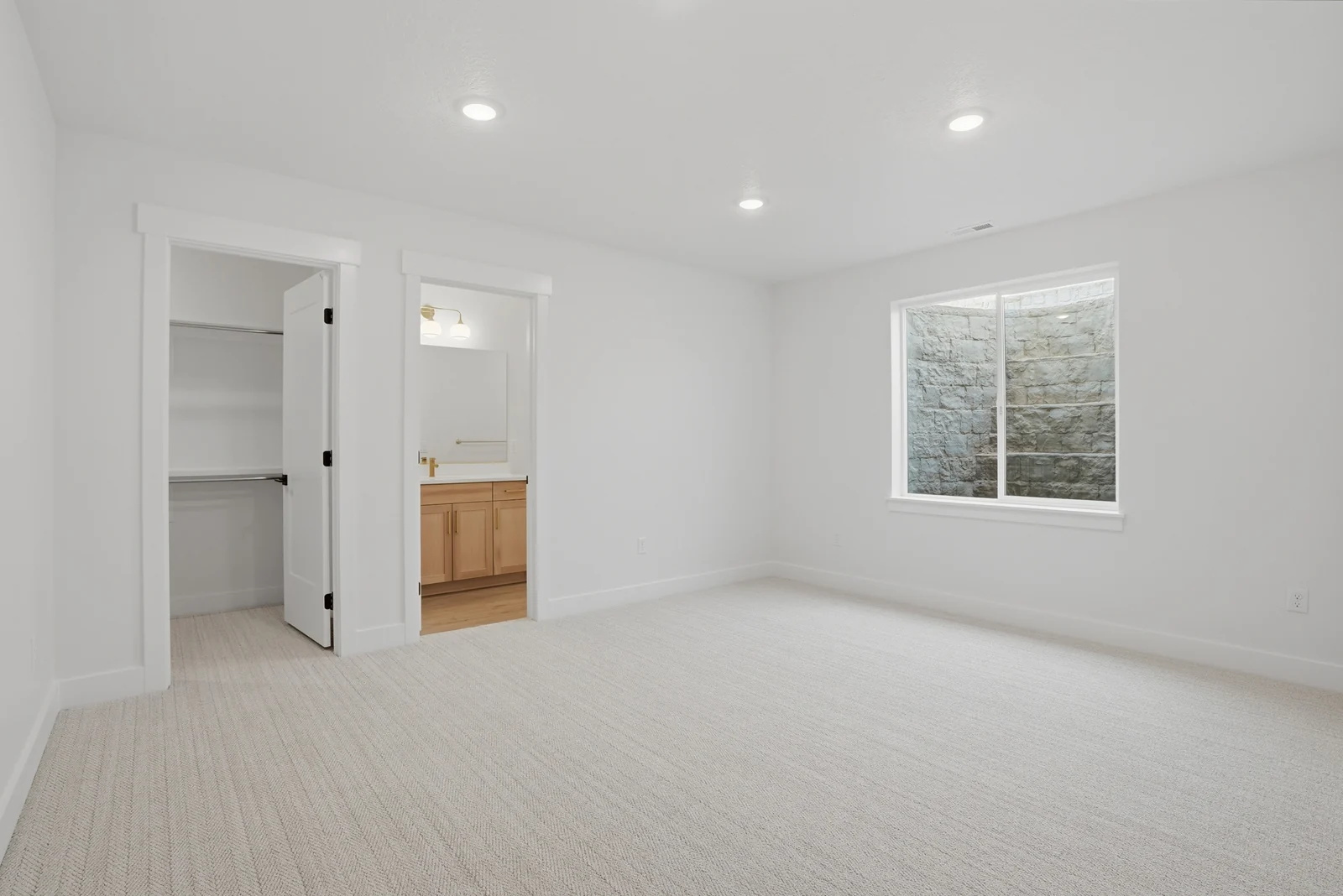 Unfurnished lower-level room with recessed lights, neutral carpet, open doorway, and single window in Olympic BH08, American Fork.