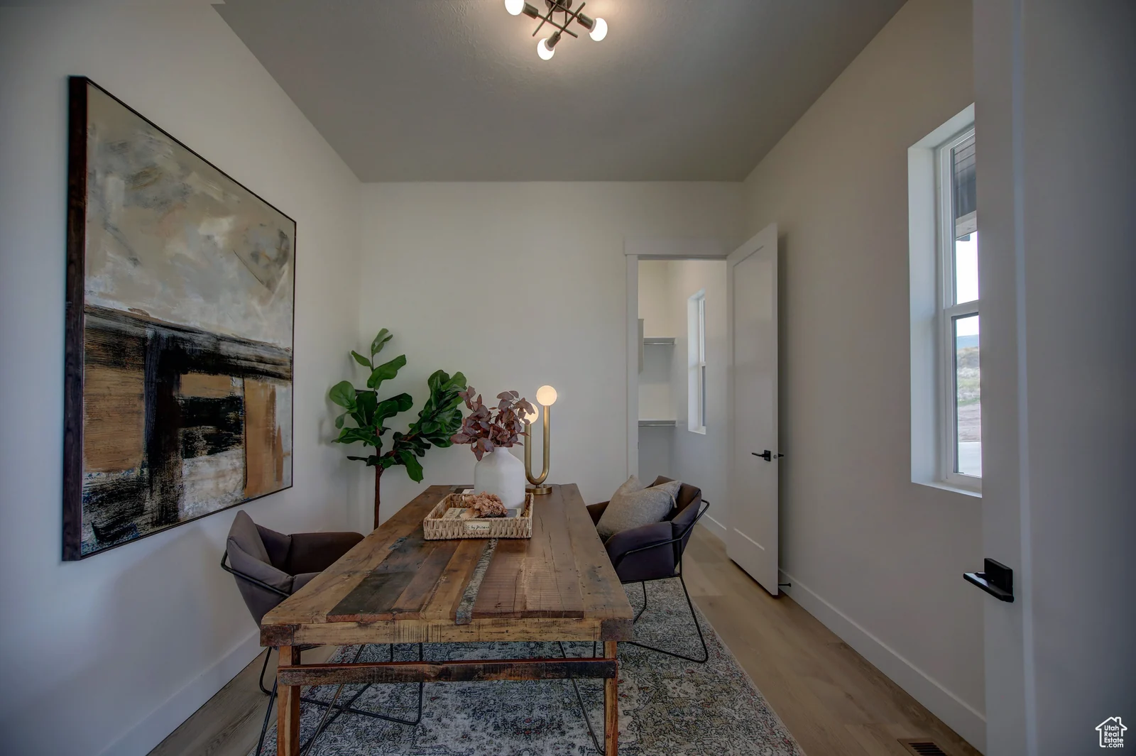 Staged office or bedroom with a desk, chair, wall-mounted television, window, and wood-look flooring in Pinnacle, Bear Lake.