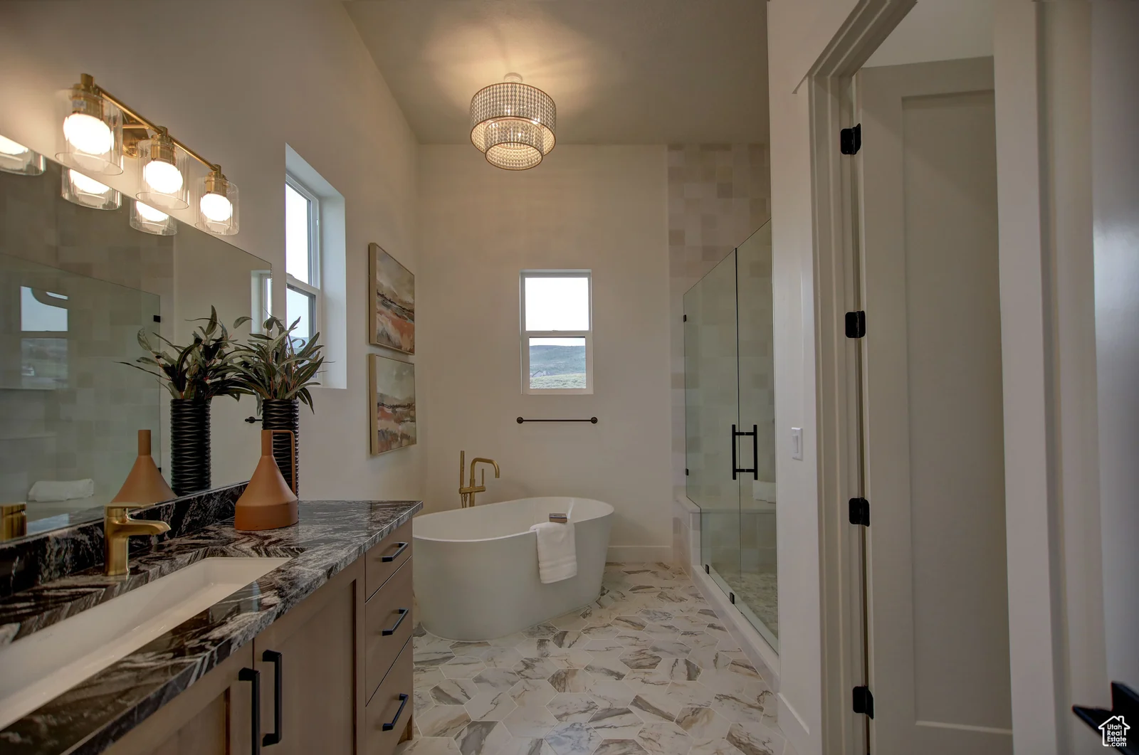 Primary bathroom with a long double vanity, freestanding tub, marble-look floor, and enclosed glass shower in Pinnacle, Bear Lake.