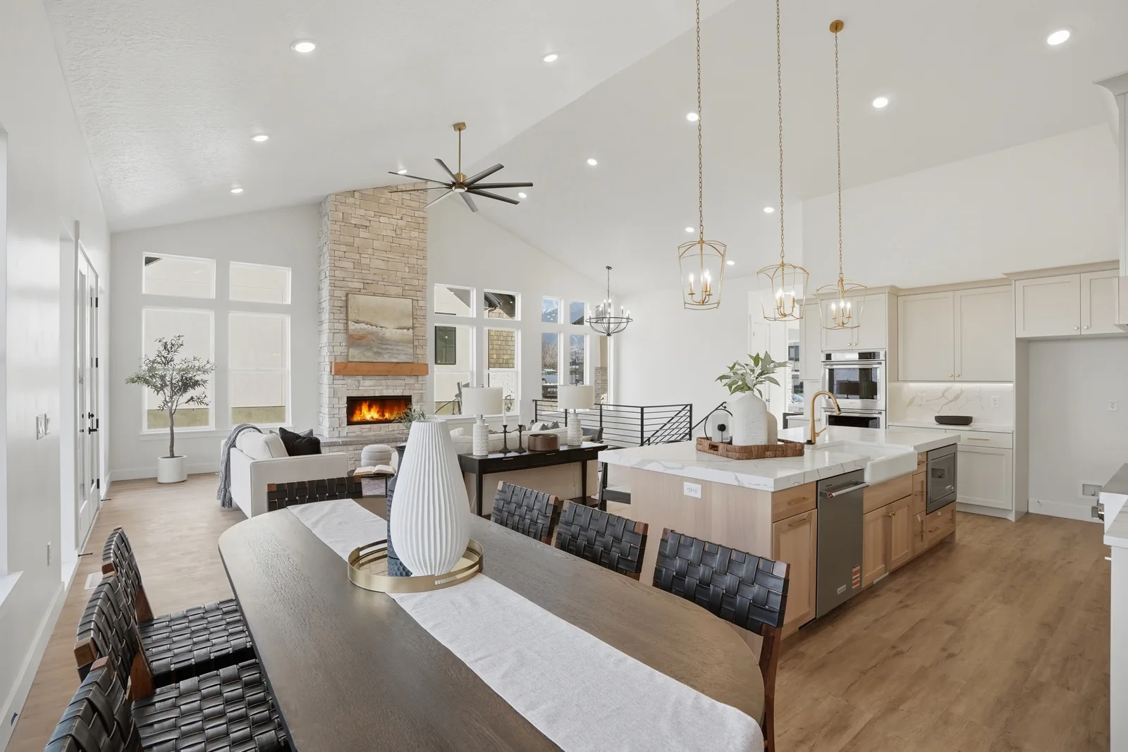 Olympic open living, dining, fireplace, and kitchen spaces