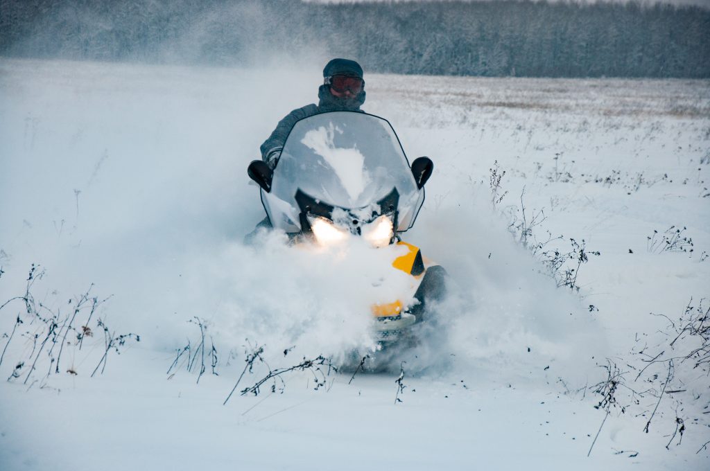 Snowmobiling in the snowy taiga. Active rest and extreme winter sport Traveling in the Khabarovsk Territory