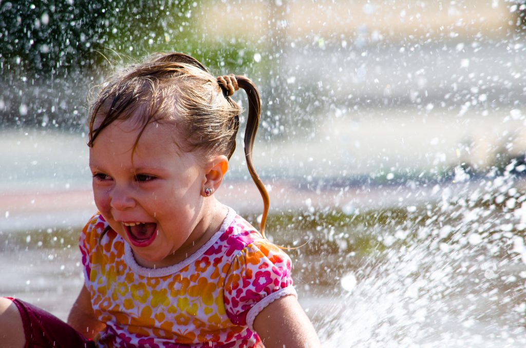 Laughing child in a summertime splash pad
